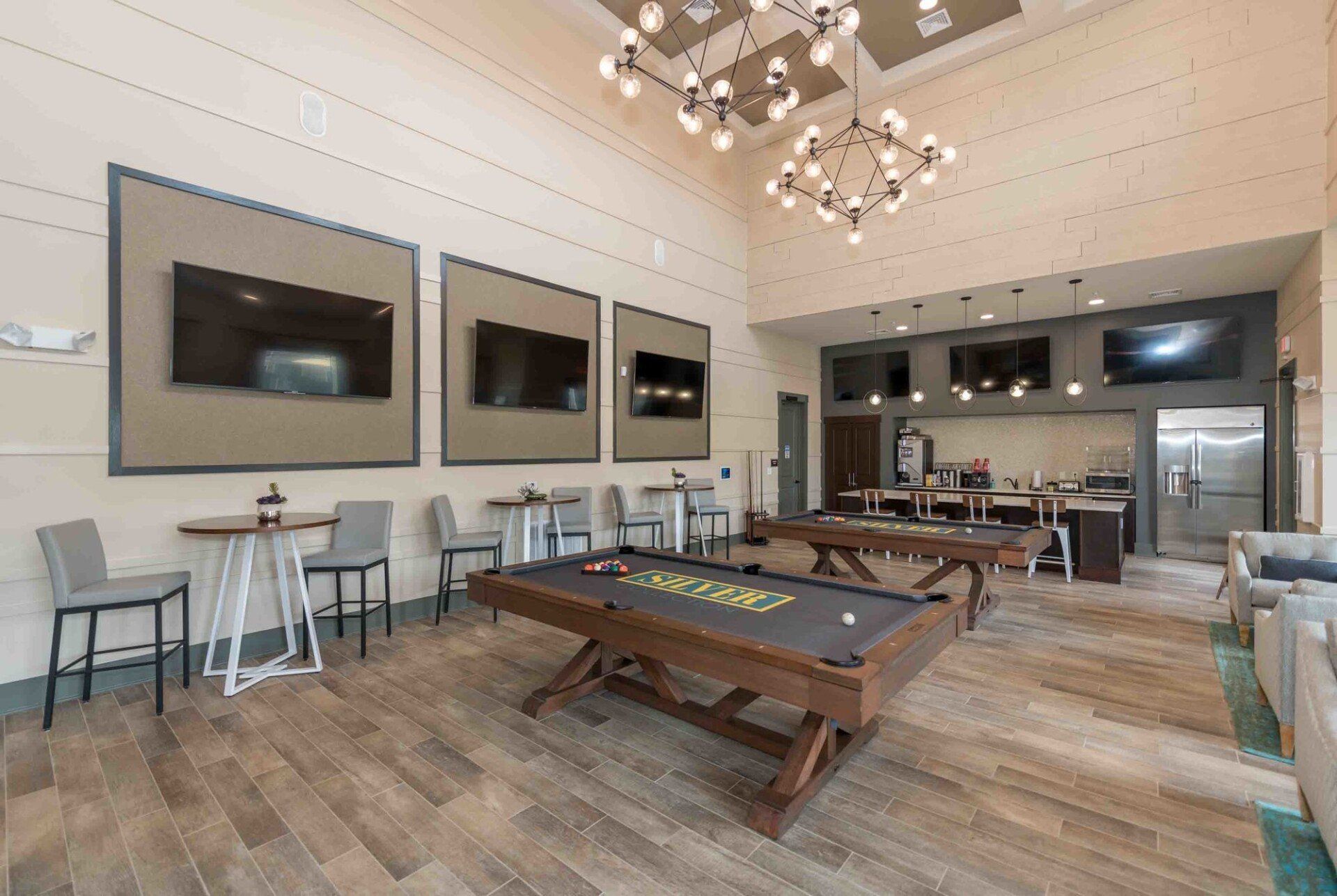 There is a pool table in the middle of the room.