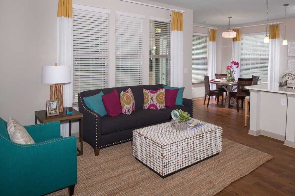 A living room with a couch , chair and coffee table.