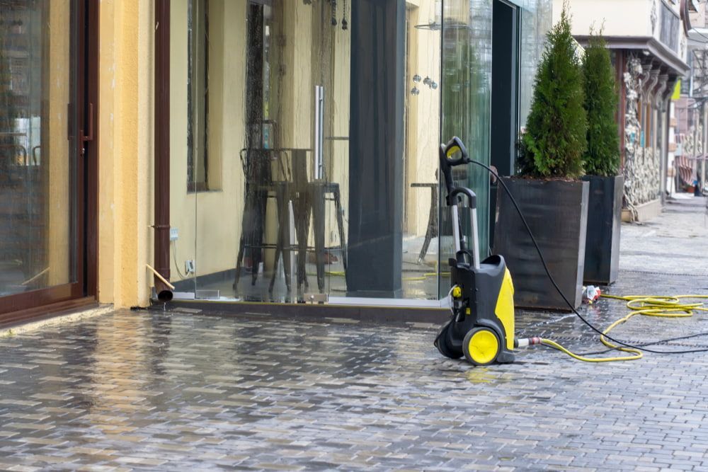 A High Pressure Washer Is Sitting on The Sidewalk in Front of A Building  — 2easy Cleaning in Bendigo, VIC