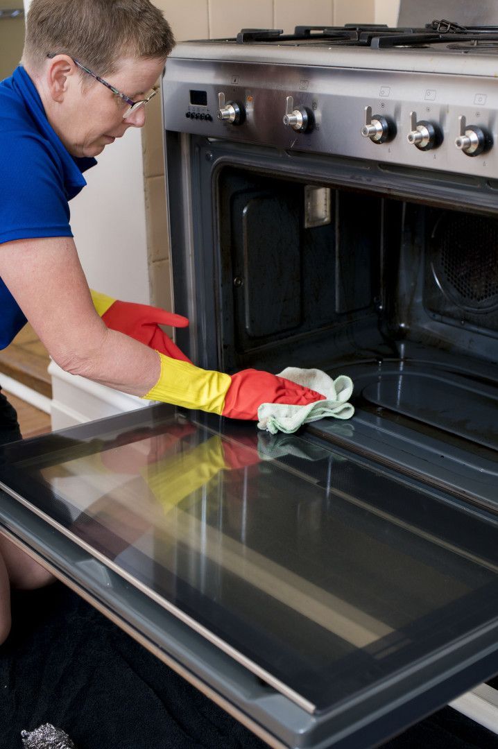 A Person Is Cleaning A Wall With A Spray Bottle — 2easy Cleaning in Castlemaine, VIC