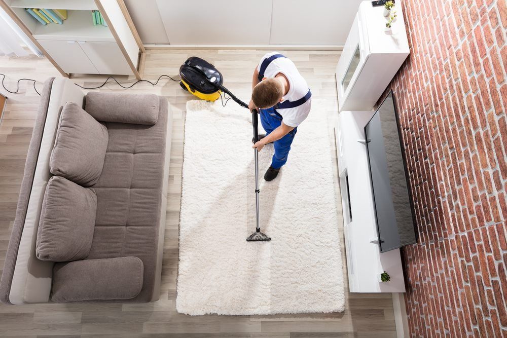 Elevated View Of Male Janitor Cleaning Carpet — 2easy Cleaning in Bendigo, VIC