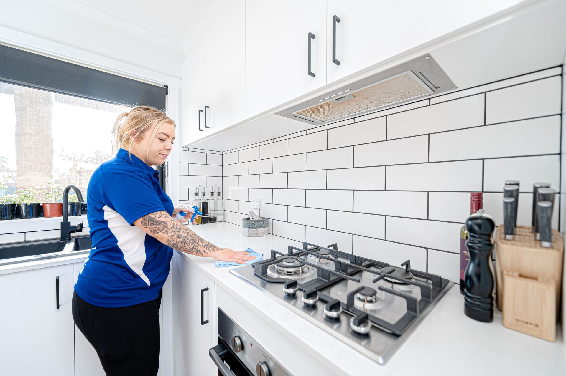 A Woman Is Cleaning A Stove Top Oven In A Kitchen — 2easy Cleaning in Bendigo, VIC