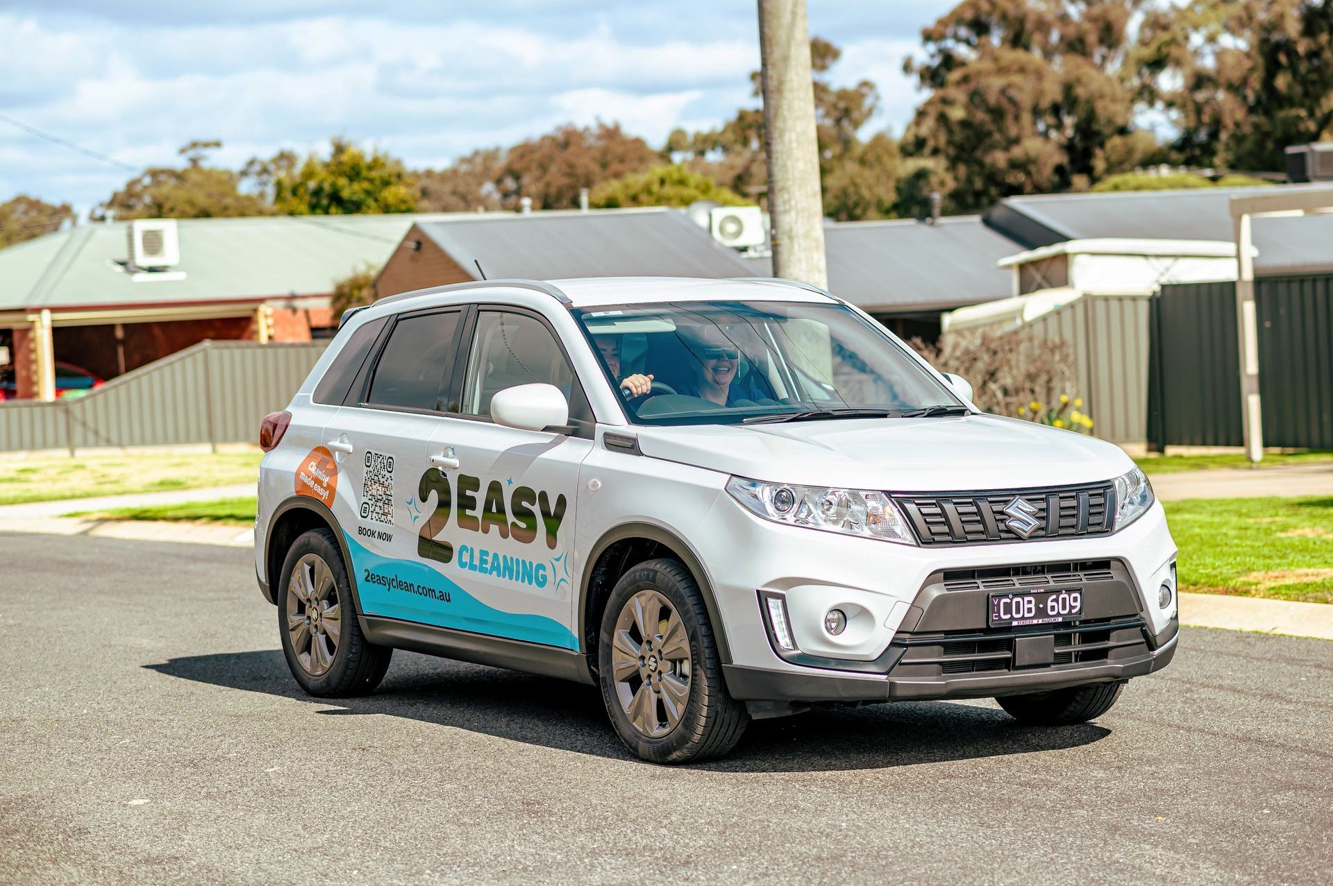 A White SUV Is Parked On The Side Of The Road In Front Of A House — 2easy Cleaning in Bendigo, VIC