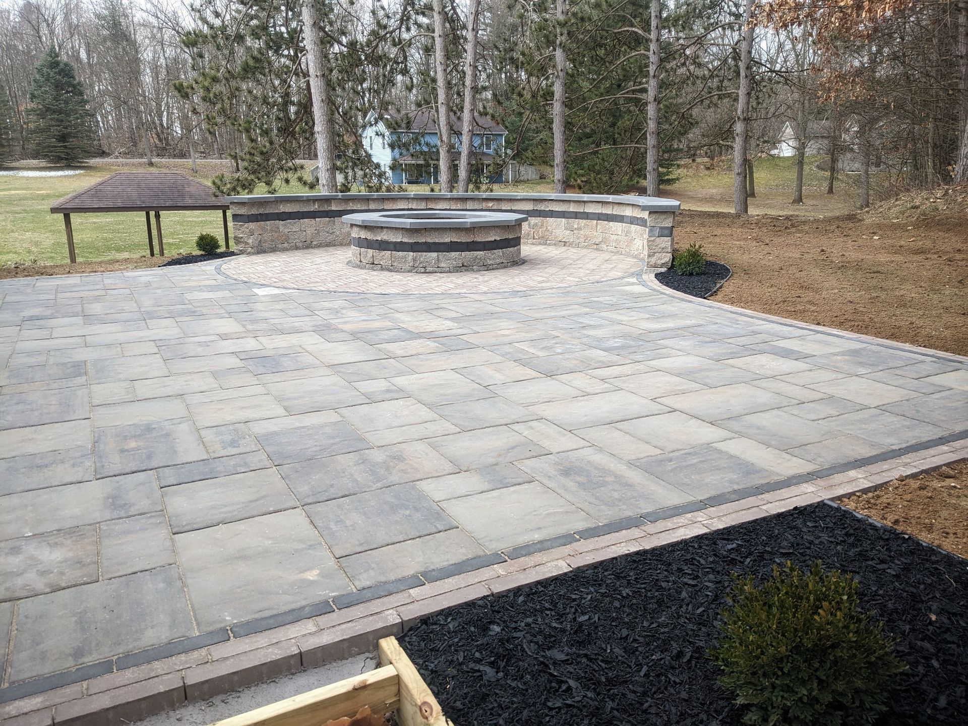 There is a fire pit in the middle of the patio.