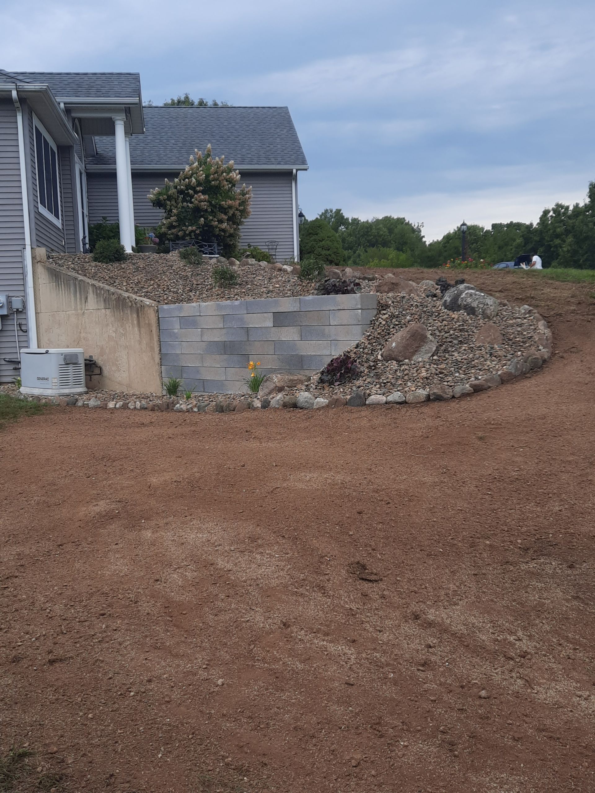 A large pile of dirt is in front of a house