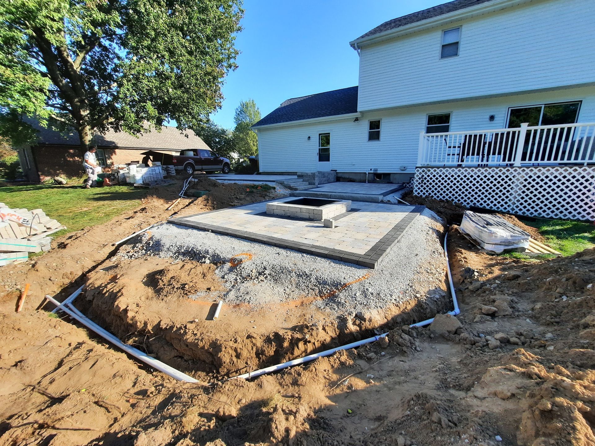 A large pile of dirt is sitting in front of a house.