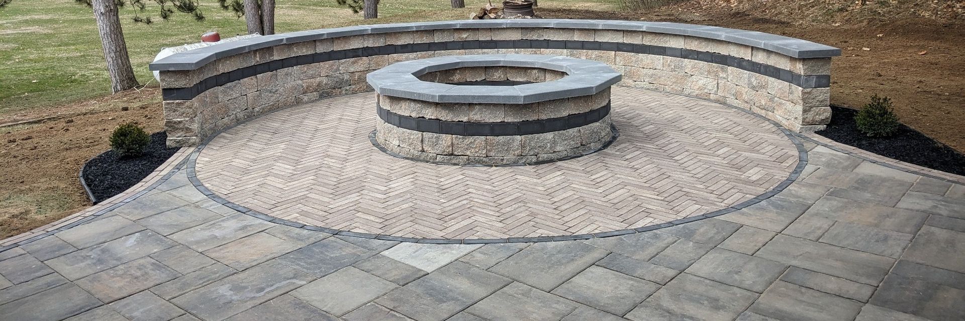 There is a fire pit in the middle of the patio.