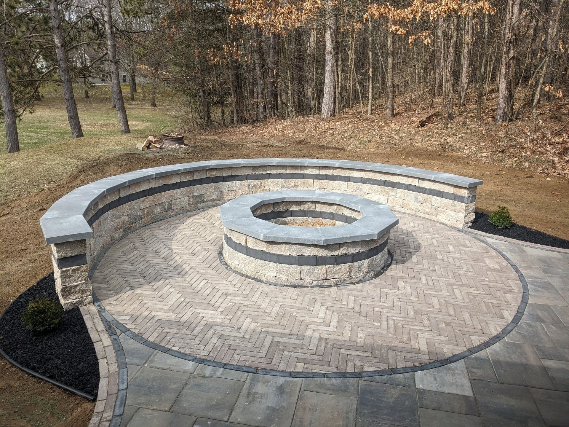 There is a fire pit in the middle of the patio.