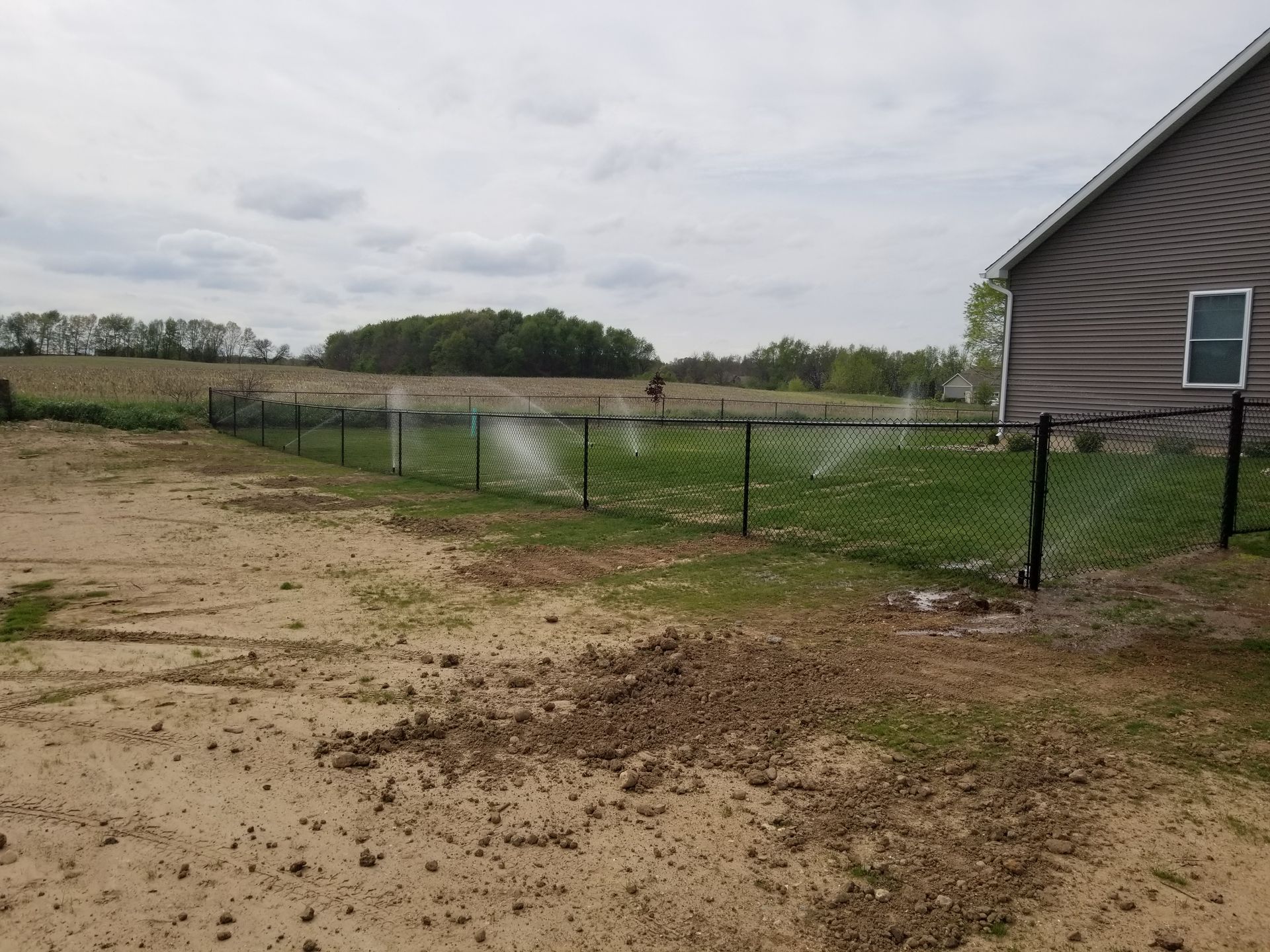A house with a chain link fence in front of it