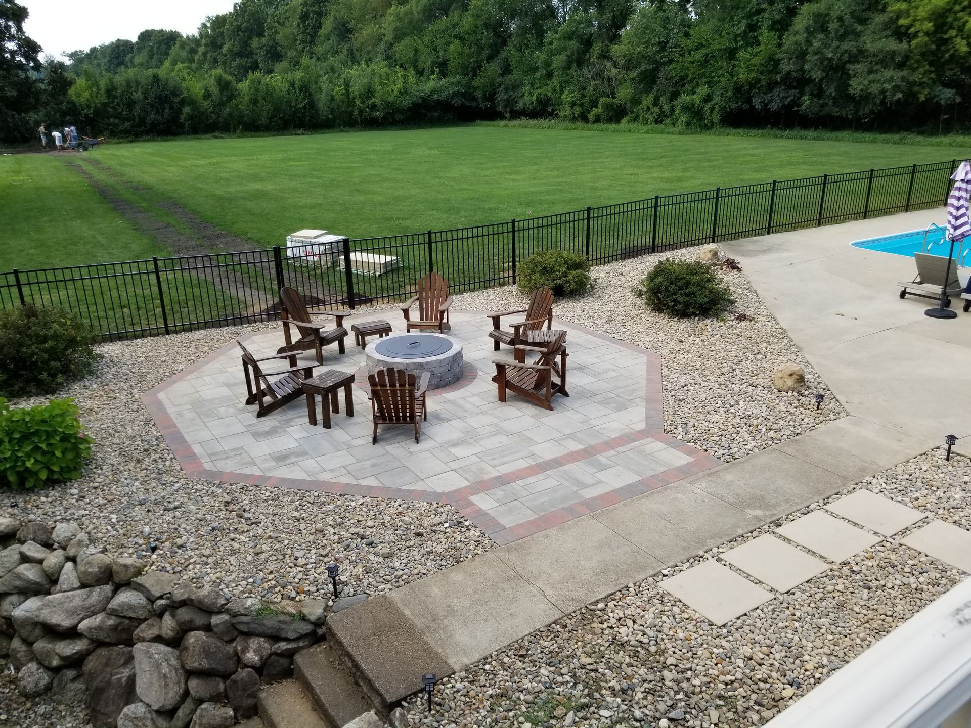 There is a fire pit in the middle of the backyard.