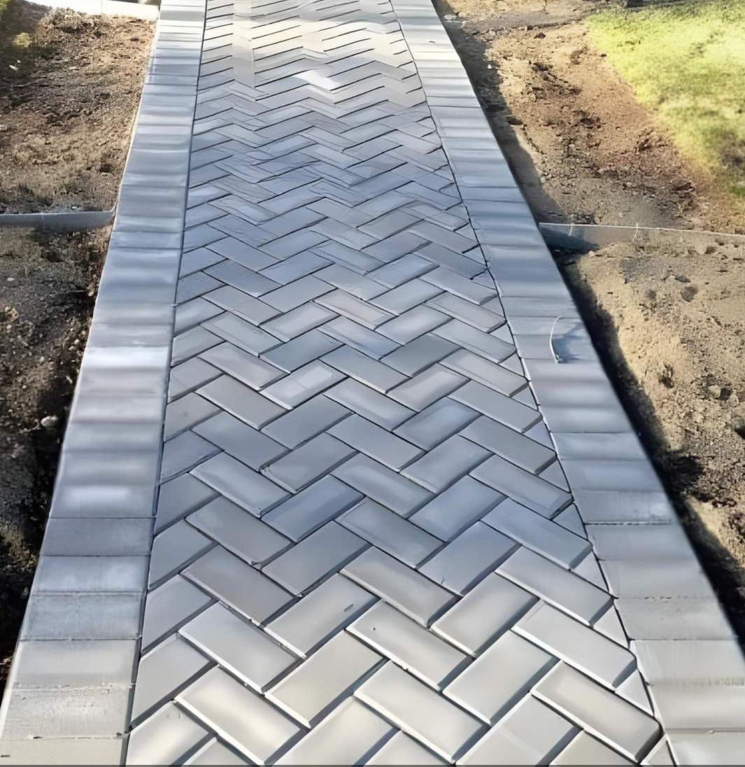 A walkway made of bricks with a herringbone pattern