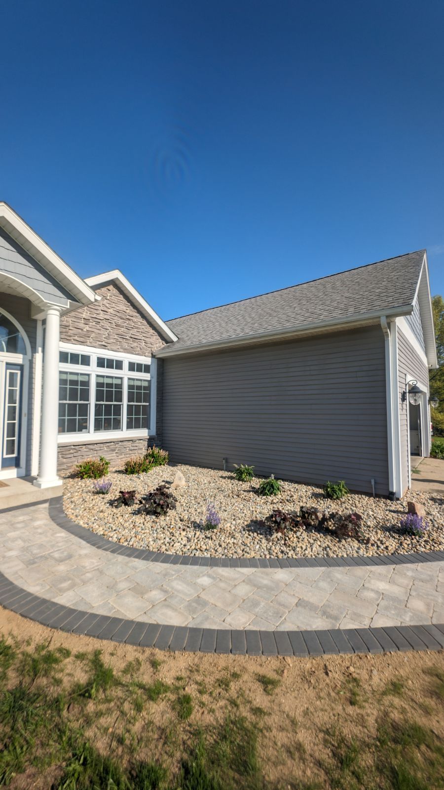 A large house with a walkway leading to it.