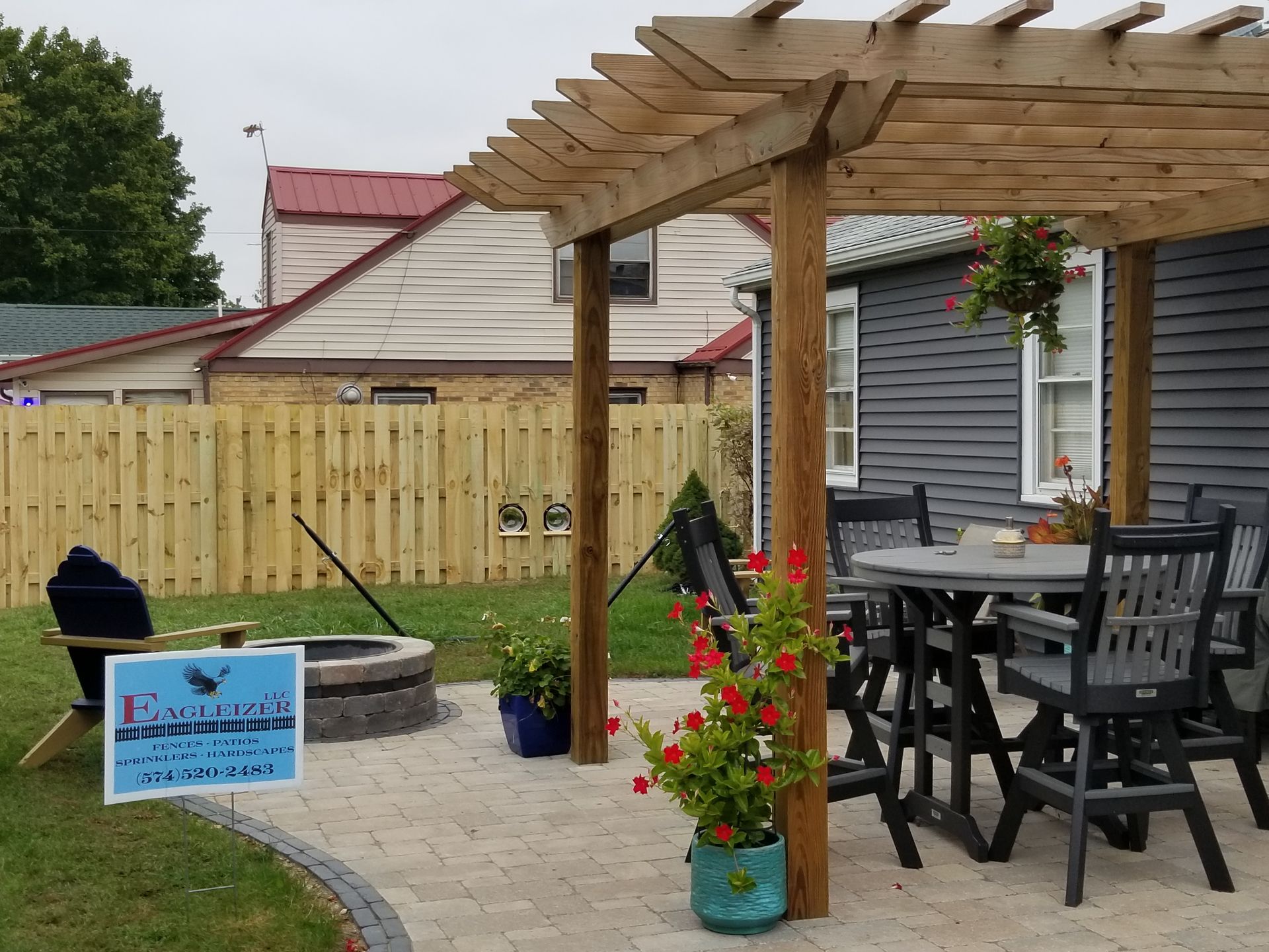 A pergola with a table and chairs underneath it