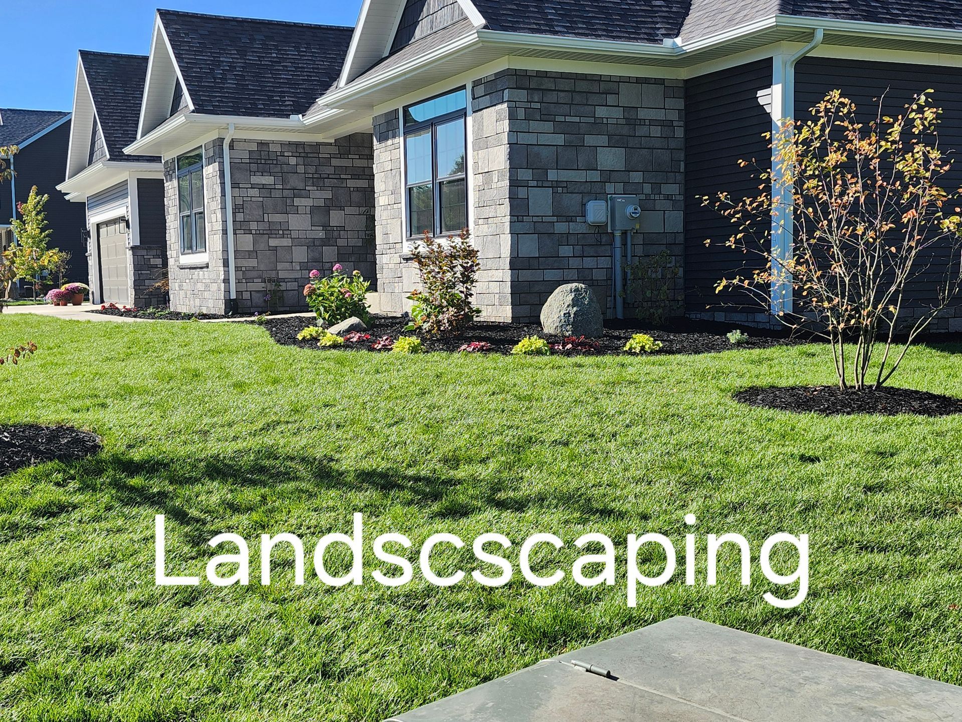 A house with a lush green lawn in front of it.