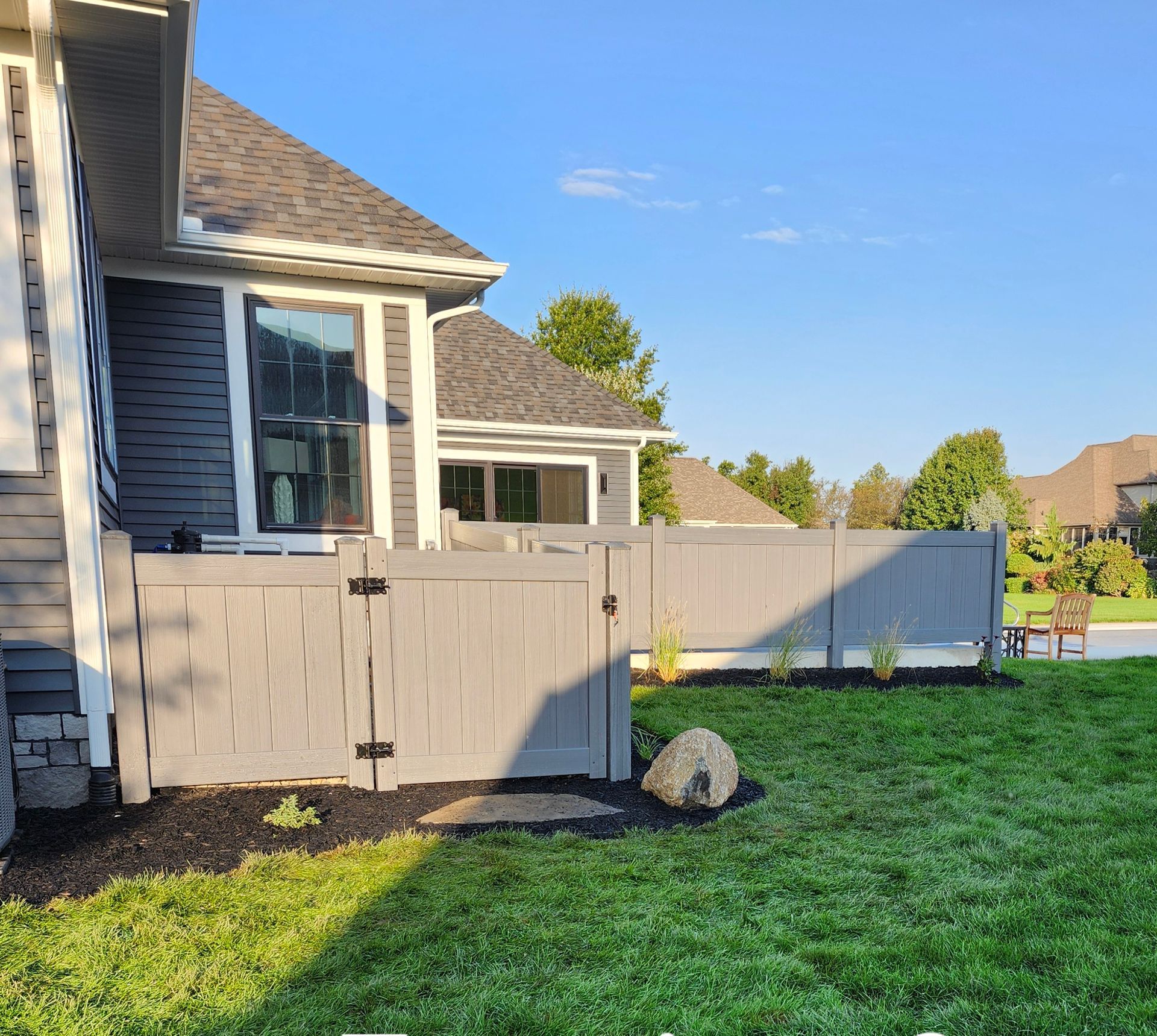 A house with a gray fence in front of it