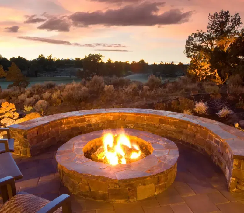 There is a fire pit in the middle of the patio.