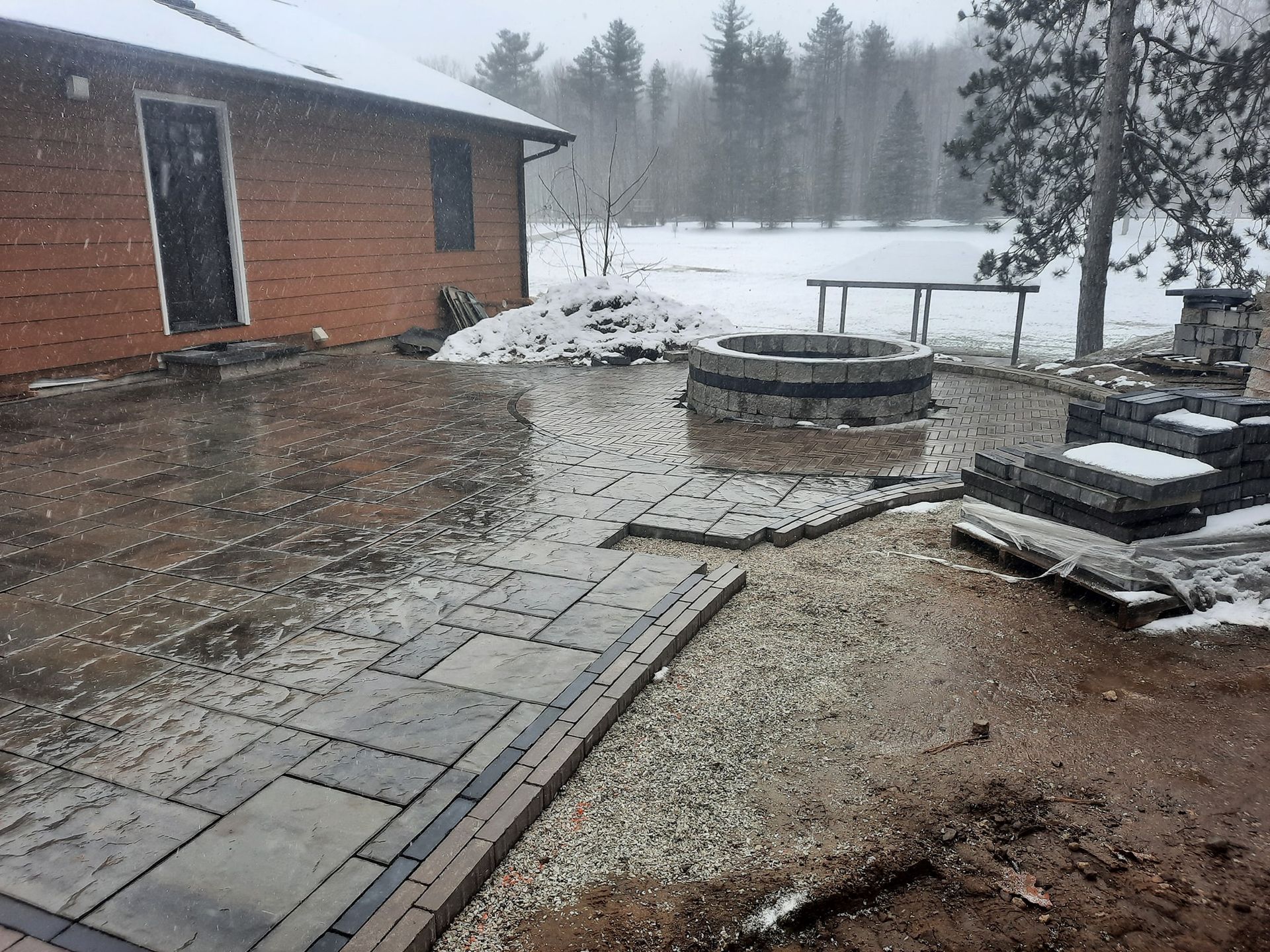 There is a fire pit in the middle of the patio.