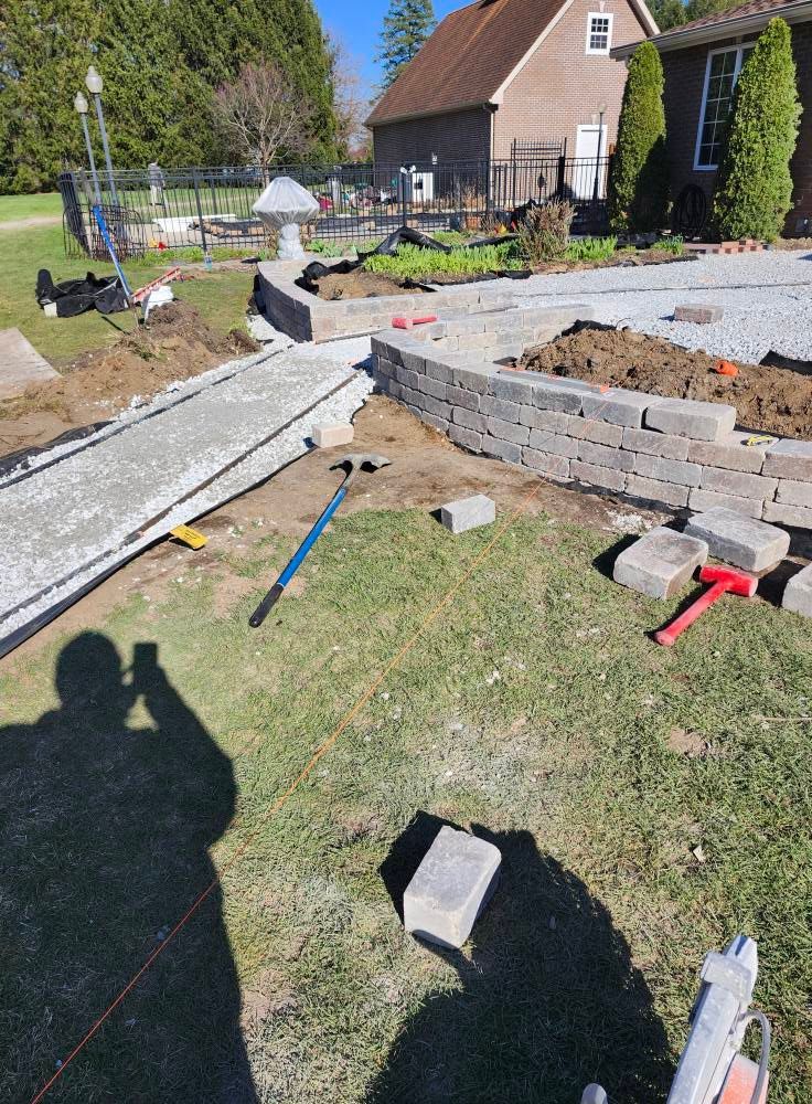 A man is taking a picture of a construction site in front of a house.