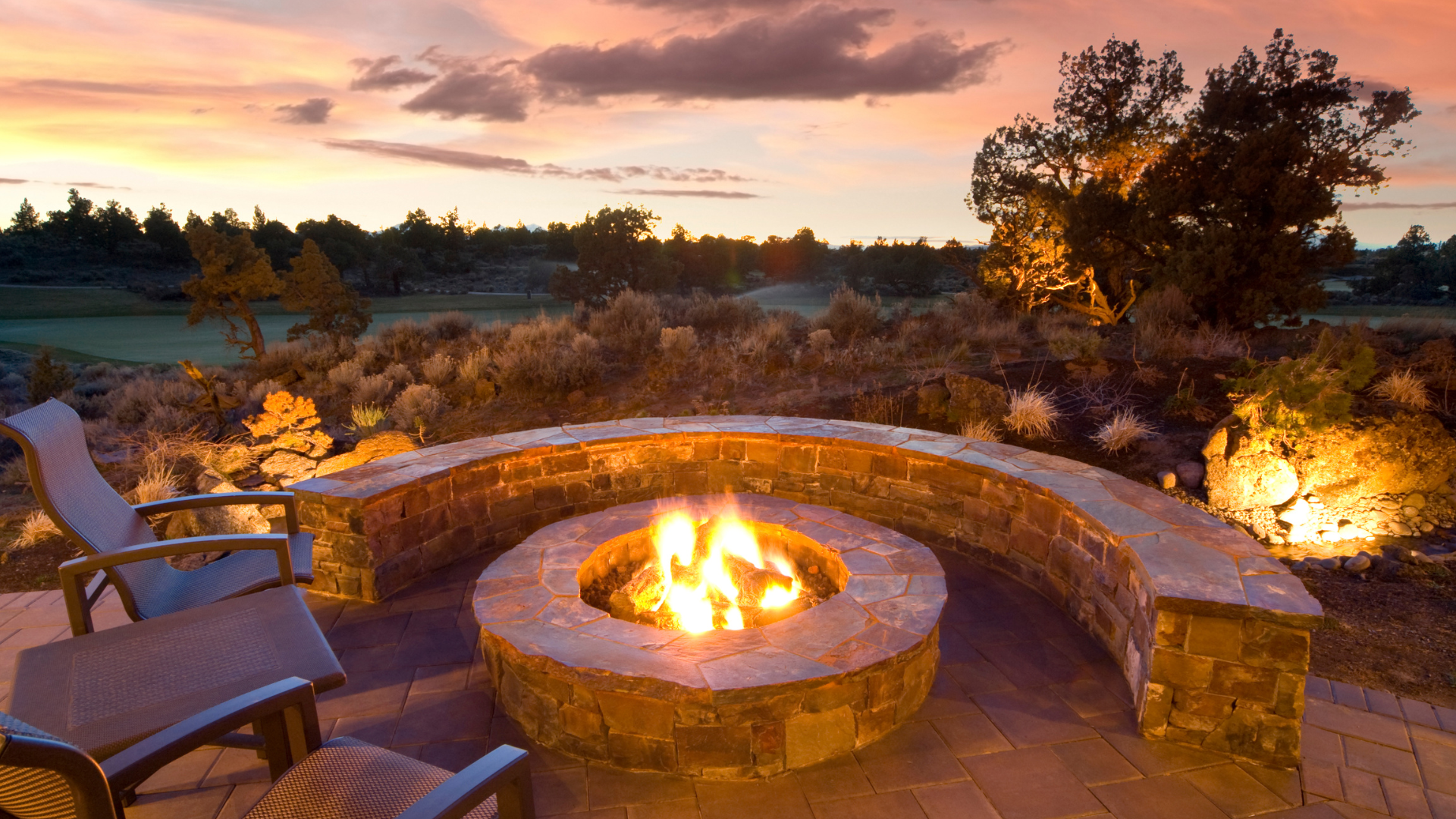 There is a fire pit in the middle of the patio.