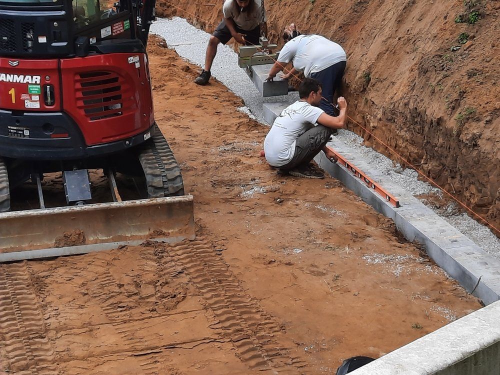 A group of men are working on a construction site next to a yanmar bulldozer.
