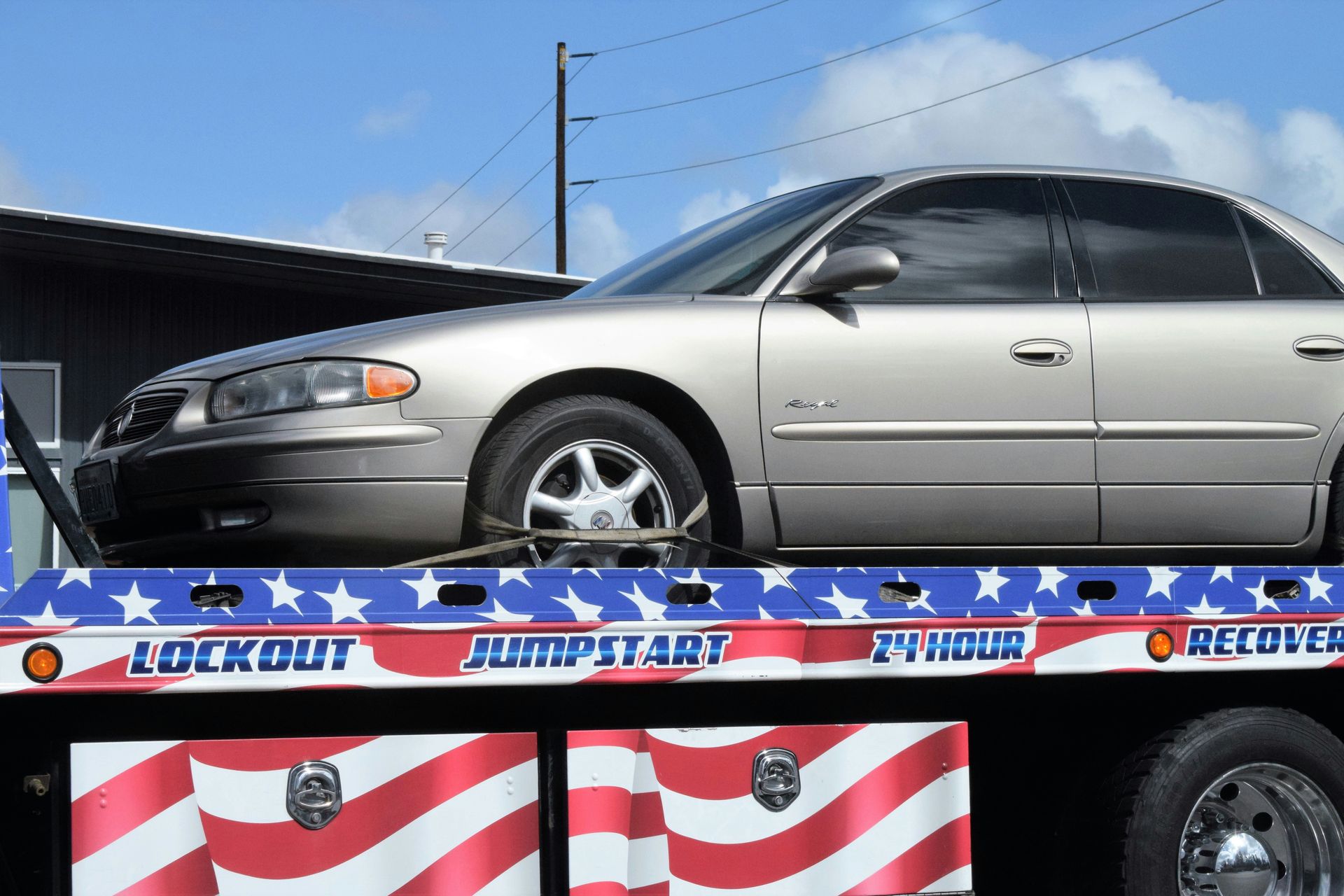 Sedan on a flatbed tow truck