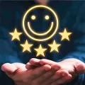 Glowing smiley and stars above cupped hands against a dark background