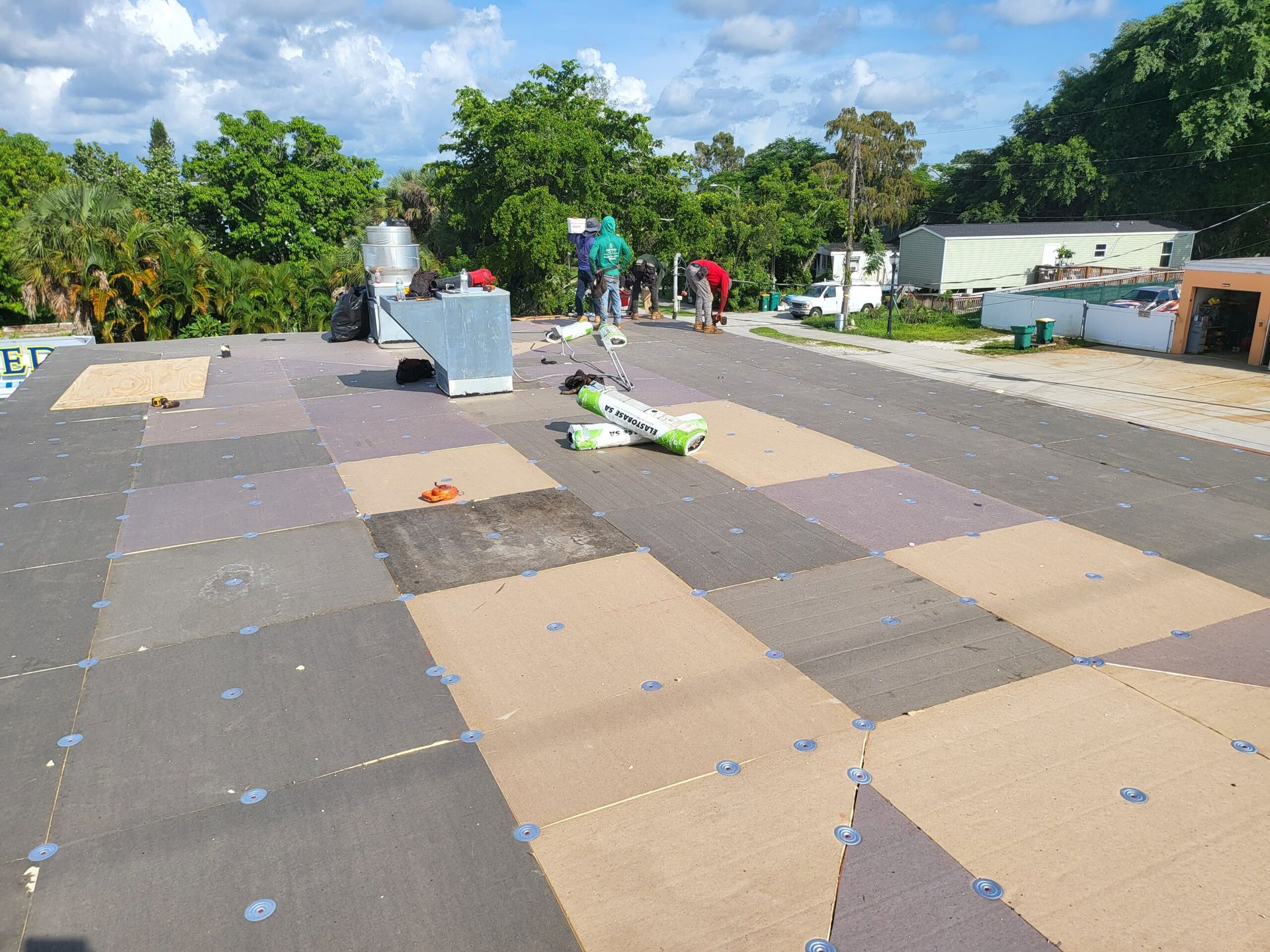 A group of people are working on a roof.