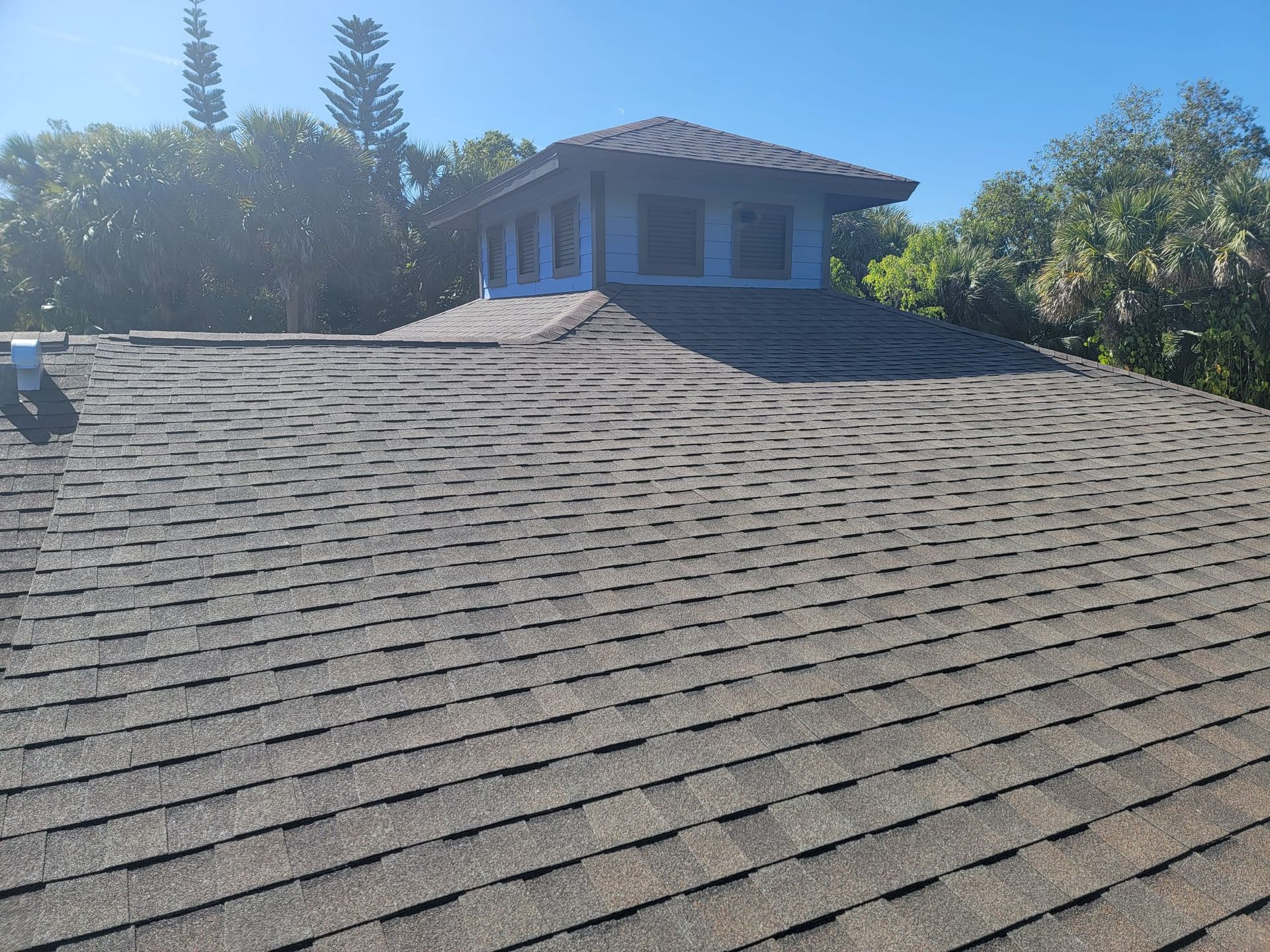 A house with a roof that has a lot of shingles on it.