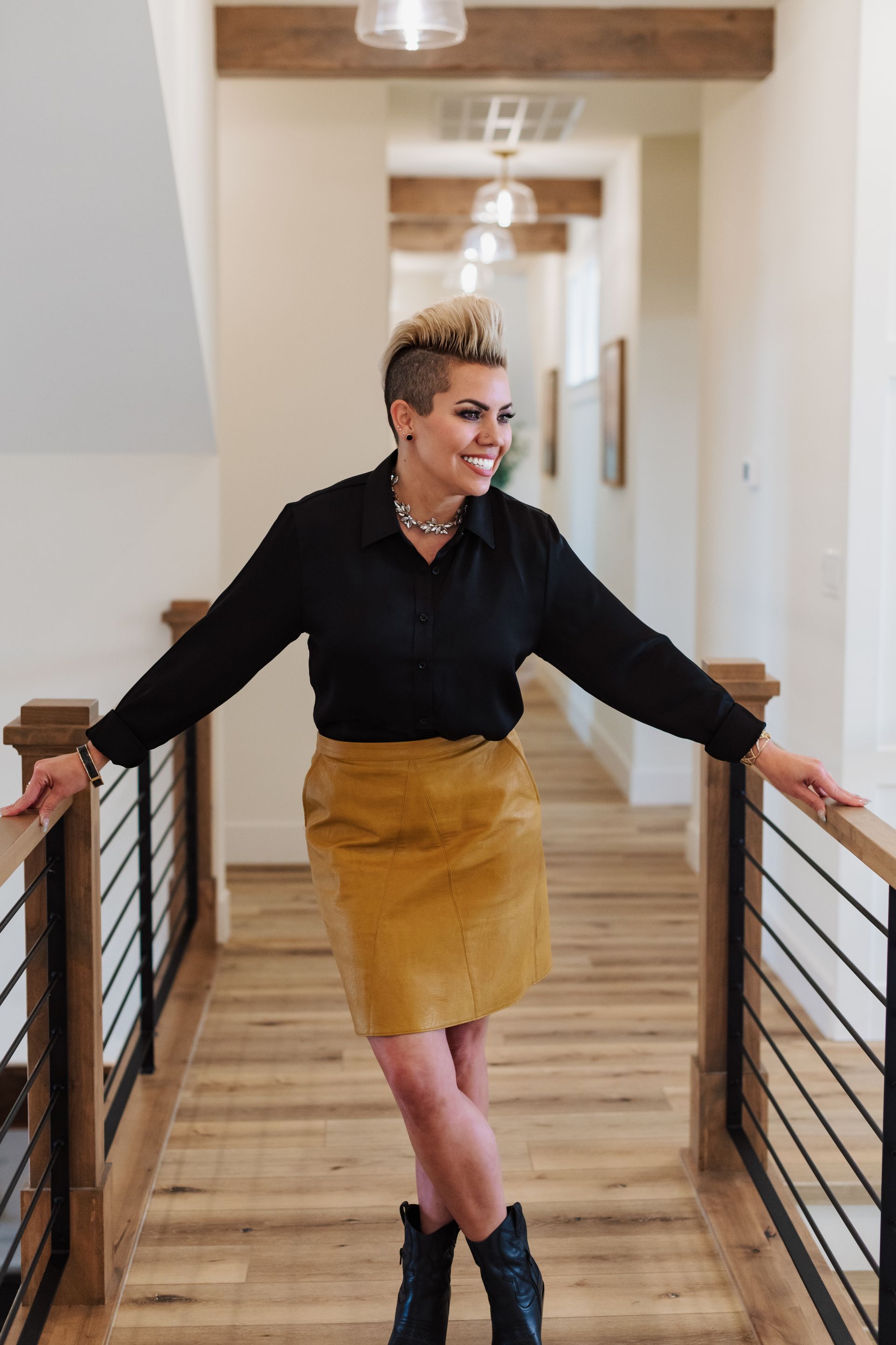 A woman standing in a catwalk gazing to the side!