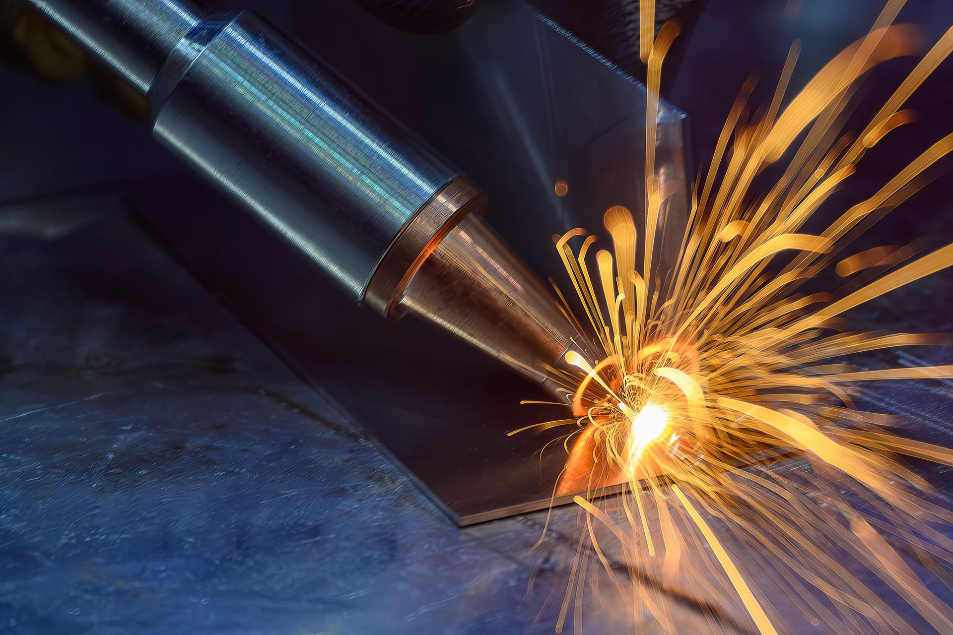 A close up of a welding machine with sparks coming out of it