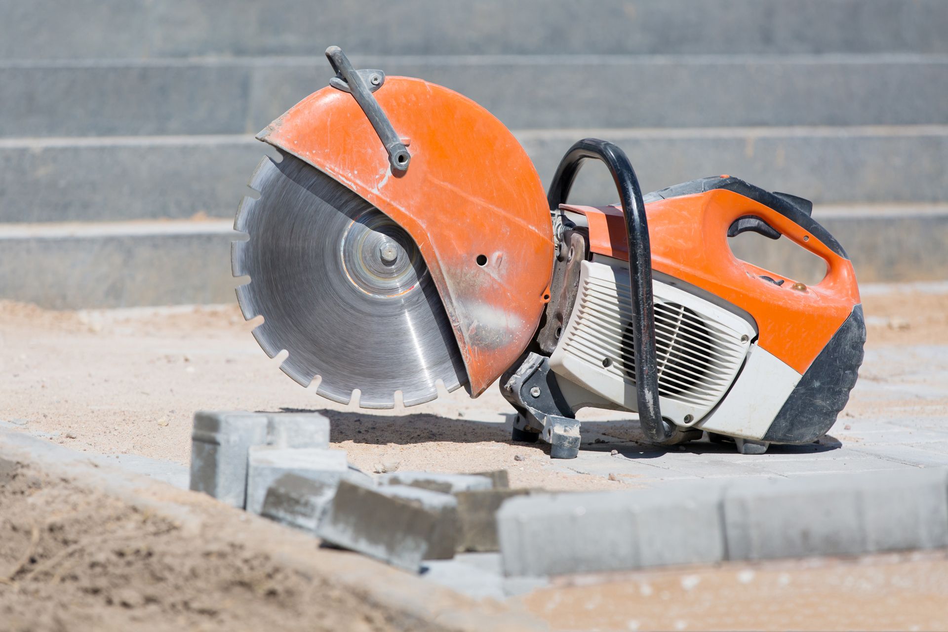 A circular saw is sitting on the ground on a construction site