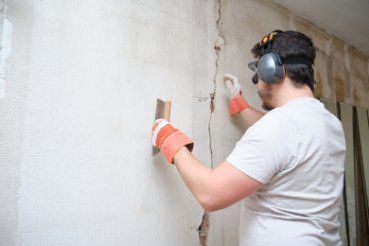 Professional concrete contractor repairing a cracked concrete wall in a residential property in Bendigo VIC.