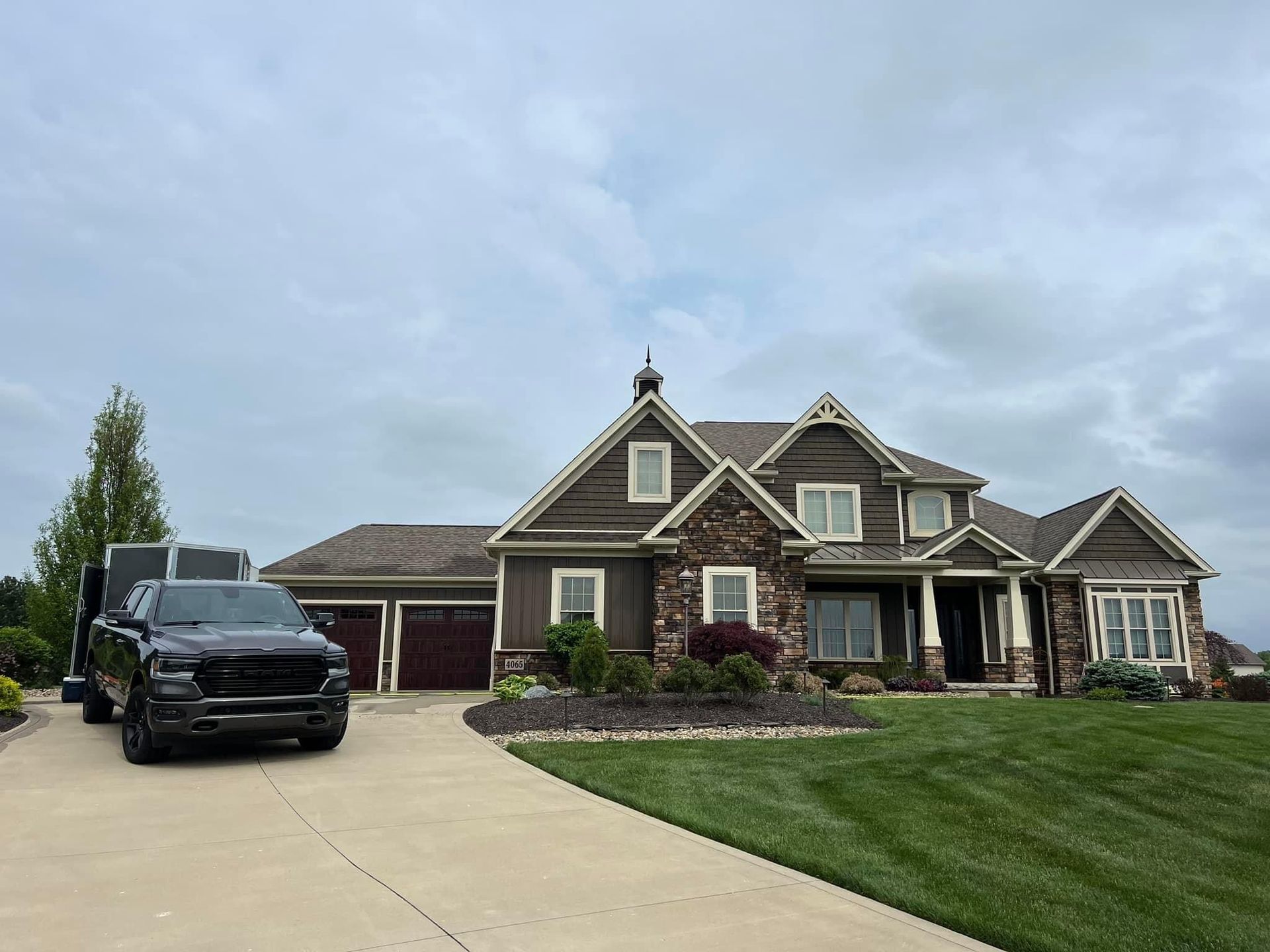 A large house with a black truck parked in front of it.