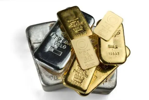 A pile of gold and silver bars on a white background