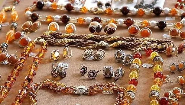 A table topped with a variety of jewelry including necklaces and earrings