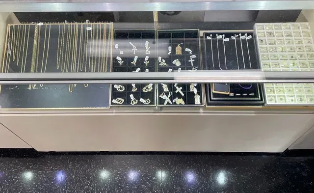 A display case filled with lots of jewelry in a store.