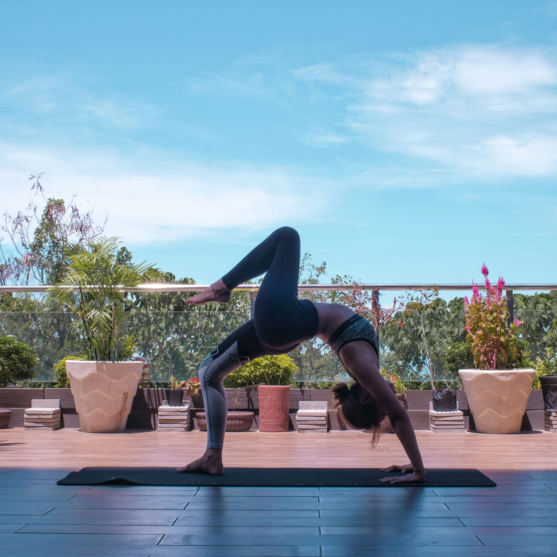 Woman practicing yoga outside, Photo by Maryjoy Caballero on Unsplash. 