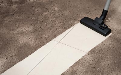 Shot Blasting — Vacuum Cleaning Dirt on a Tiled Floor in Jacksonville, FL