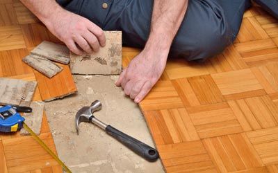 Floor Removal Services — Worker Removing Damaged Parquet in Jacksonville, FL Floor Removal Services — Worker Removing Damaged Parquet in Jacksonville, FL