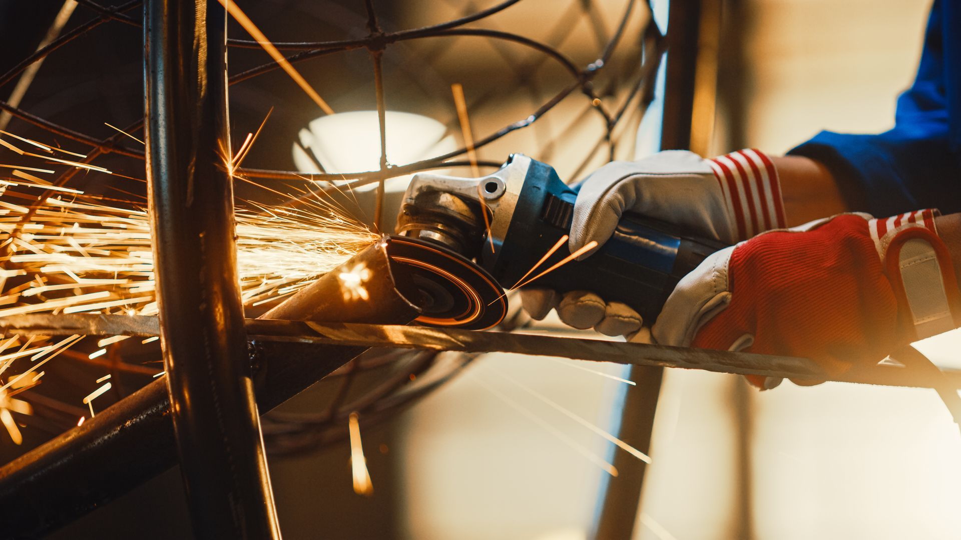 A person is grinding a piece of metal with a grinder.