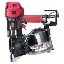 A group of tools are sitting on a wooden floor.