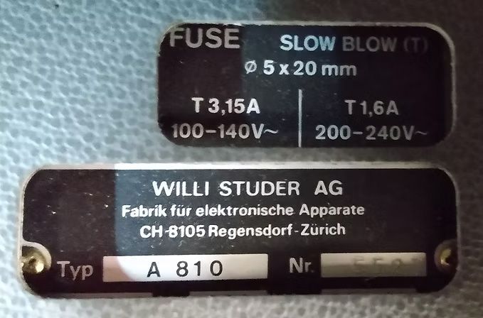Two black equipment labels with white text: One states