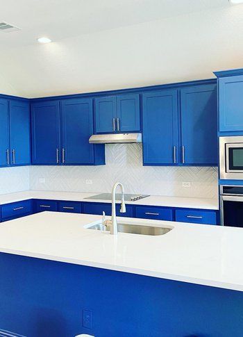 Home in Austin, TX that had kitchen remodel including cabinet painting, new countertops, and new backsplash completed by Austin Painting and Cabinets