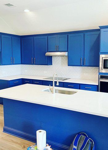 Home in Austin, TX that had kitchen remodel including cabinet painting, new countertops, and new backsplash completed by Austin Painting and Cabinets