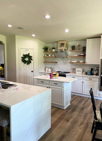 Home in Lake Travis area of Austin, TX that had kitchen remodel including cabinet painting and new countertops completed by Austin Painting and Cabinets