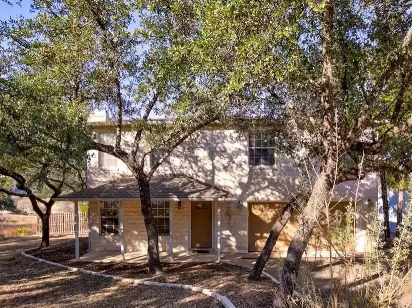 Before photo of Austin exterior painting project with unpainted siding trim and deck