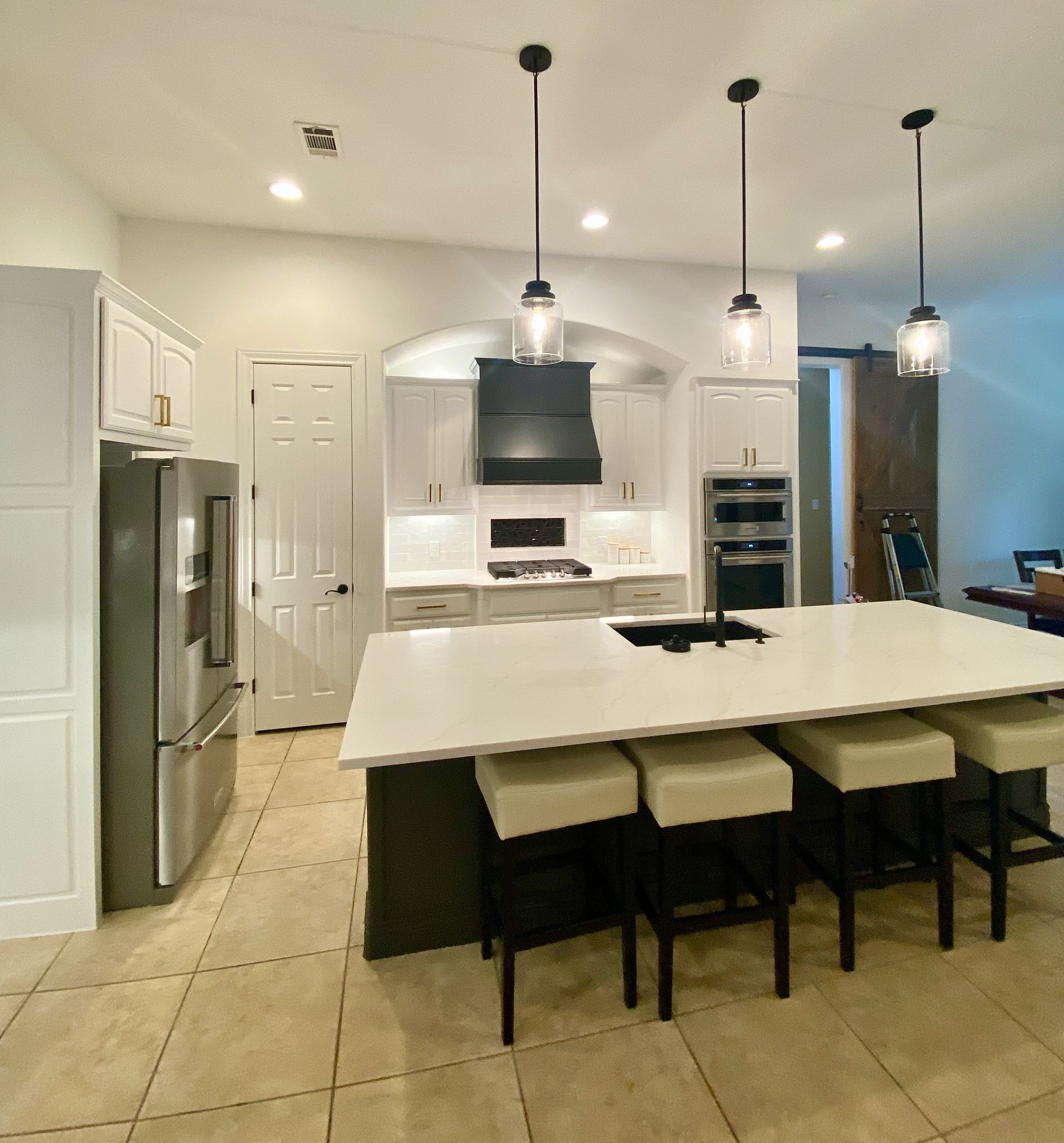 Austin kitchen remodel in Brushy Creek with custom vent hood painted cabinets quartz countertops and