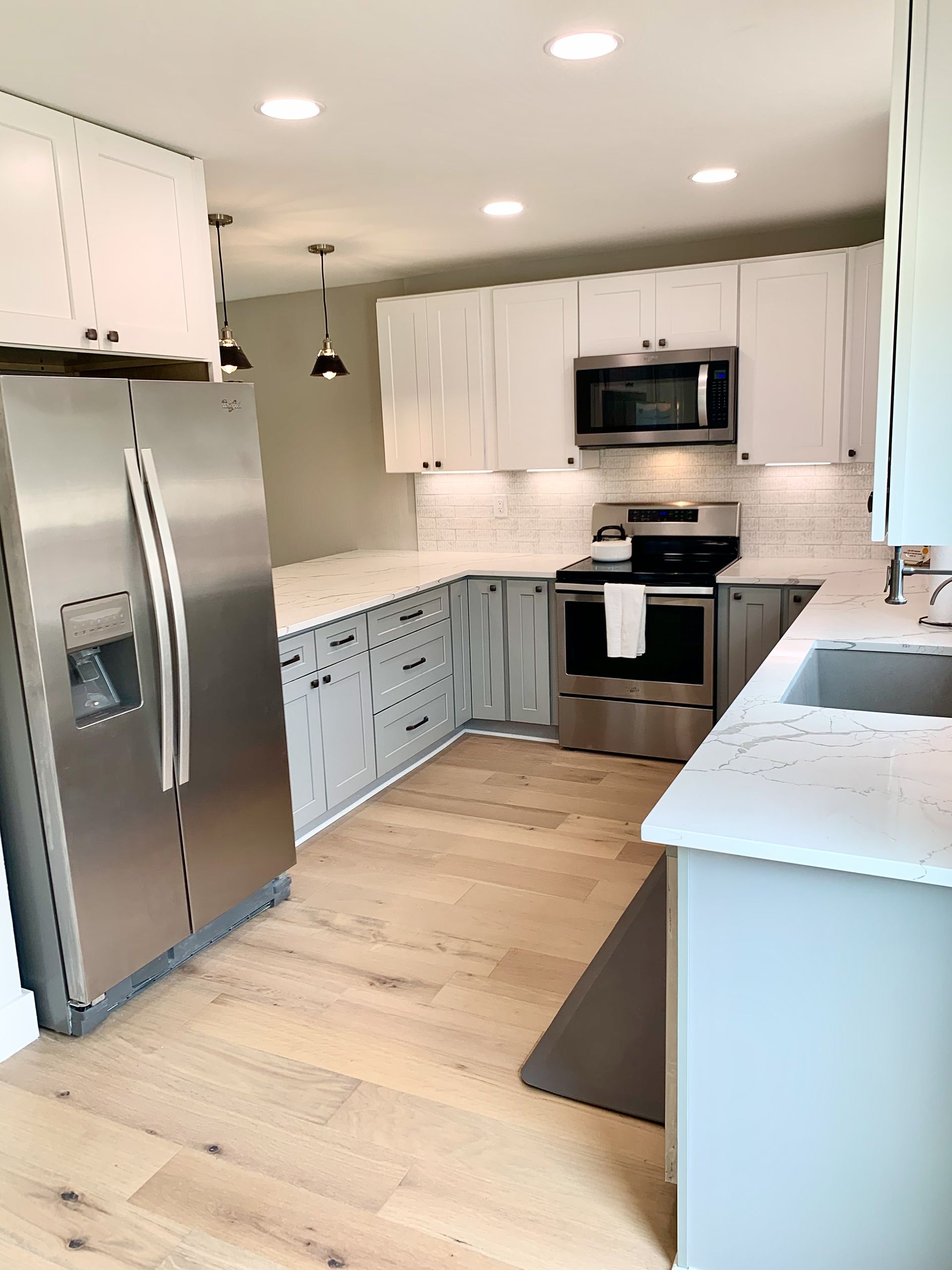 After photo of Dripping Springs kitchen remodel with open concept shaker cabinets quartz countertops