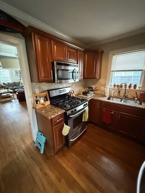 Kitchen before remodel in downtown Austin with dark cabinets and outdated finishes