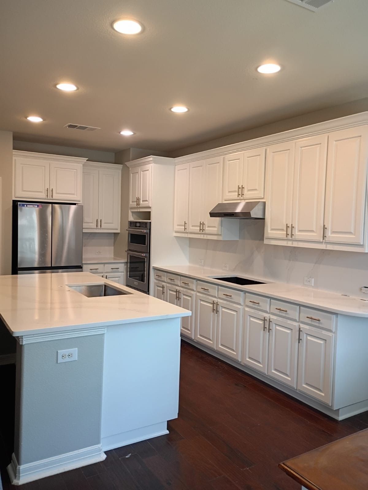Leander kitchen remodel with cabinet refinishing, quartz countertops, backsplash, and hardware upgra